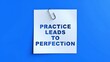 © TAIFUR - White paper note with cut-out letters saying 'PRACTICE LEADS TO PERFECTION' held by a silver paperclip on a vibrant blue background