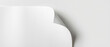 © Black - A white bottle with a curved shape is partially visible against a white background with soft shadows on the right side