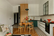 © FollowTheFlow - Stylish Apartment Interior with Wood and White Accents and Dining Area