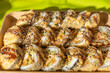 © Jakob - Crispy fried sushi rolls with sesame and teriyaki sauce served in a cardboard tray. Golden breadcrumbs, rice, cucumber, and chicken create a tempting Asian street food look.
