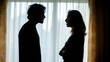 © Bonsales - Silhouetted couple having a heated argument, experiencing relationship dispute, conflict, and communication breakdown