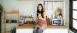 © Stella 16 - woman enjoying beautiful morning with cup of coffee using smartphone scrolling social media at sunny kitchen Charming young female relaxing and chatting on mobile phone at home