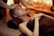 © InfiniteFlow - Caucasian woman enjoying relaxing anti-stress head massage and pampering facial beauty skin recreation leisure in warm candle lighting ambient salon spa in luxury resort or hotel. Quiescent