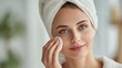 © LimeSky - Attractive lady cleansing her face with a cotton pad inside