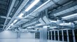 © twilight mist - Exposed metal ventilation and lighting systems dominate the ceiling of a large interior industrial space housing equipment racks