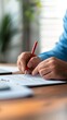 © Ndoomyim - Focused man engrossed in writing on paper capturing thoughts and ideas with pen man diligently writing recording thoughts and ideas on paper with a pen.