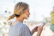 © luismolinero - Young blonde woman using mobile phone at outdoors in back position