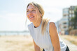 © luismolinero - Young blonde woman at outdoors wearing sport wear with happy expression