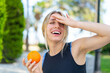 © luismolinero - Young blonde sport woman holding an orange at outdoors has realized something and intending the solution