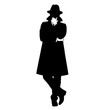 © widayanto - Silhouette of a mysterious person in a long coat and hat.