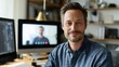 © KASUEMA SALAE - Smiling businessman on video call using dual monitors in home office, online communication concept