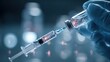 © Pixels by Nazrul - Close-up of a syringe drawing liquid from a glass vial with a blurred blue background, representing vaccination and medical treatment
