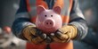© Inna - Construction Worker Holding Piggy Bank for Financial Security