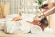 © InfiniteFlow - Serene ambiance of spa salon, couple indulges in rejuvenating with luxurious face cream massage with modern daylight. Facial skin treatment and beauty care concept. Quiescent