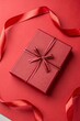 © Anastasiia Kasina - Red gift box on the red background. Copy space, top view