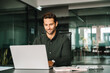 © Stock 4 You - Happy latin hispanic young business man working on laptop computer in company office. Smiling European entrepreneur manager businessman using pc for communication, learning at workplace. Copy space