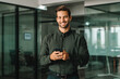 © Stock 4 You - Smiling portrait latin Hispanic business manager using cell phone mobile looking at camera. European young student man businessman holding smartphone in office, working, trading and banking online