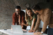 © Novak - Diverse group of young professionals collaborating on a project in a modern startup office