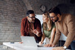 © Novak - Diverse group of young professionals collaborating on a project in a modern startup office