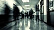 © neirfy - A somewhat blurry hospital corridor filled with numerous people walking about on their various errands and duties