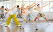 © JackF - Teenage girl rehearsing hip hop dance in group in dance studio