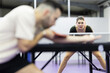 © KONSTANTIN SHISHKIN - Young woman concentrating playing competitive table tennis