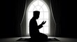 © fauzannurarifin - Man praying silhouette in front of an arched window with soft glow