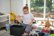 © Volodymyr - Child cleaning messy playroom at home. Kid organizing scattered toys on the floor. Kid helping tidy up children messy room. Boy cleaning untidy playroom interior. Kid picking up toys in messy room.