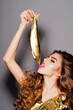 © Volodymyr - Beauty woman eat Golden Fish. Fashion girl eat golden Fish. Gold luxury concept, beauty portrait. Luxury with gold. Glamorous beauty desire. Fashion portrait with bread.