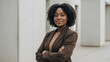 © NeutralStudio - African american beautiful female businesswoman ceo woman with confident arm folded portrait at work black suit outdoor modern office building background