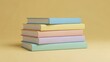 © MDRAKIB - Stack of Pastel Colored Books on Yellow Background