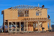 © Eduardo Barraza - Construction crew framing a two story wooden home under construction, representing residential housing development, structural assembly, and active jobsite building operations