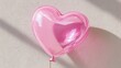 © Iaroslav - Pink heart balloon encased in clear bubble for love, romance, and valentine's day celebrations against background a solid