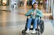 © Serhii - Navigating a shopping center in a wheelchair