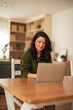 © Jelena - Woman working on laptop remote from home