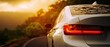 © Khat - The white car driving on winding mountain road at golden sunset
