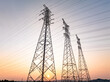 © zhu difeng - Power transmission towers at sunset