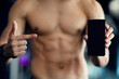 © Prostock-studio - Workout App. Muscular Man With Naked Torso Pointing At Blank Smartphone With Black Screen, Unrecognizable Shirtless Athlete Recommending New Fitness Application Or Website, Mockup, Selective Focus