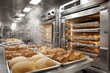 © Popelniushka - Commercial bakery oven with stainless steel racks and freshly baked bread in a busy kitchen