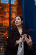 © BullRun - Confident Hispanic woman using smartphone with composed expression, suggesting digital fluency, focus, and empowerment in personal technology routine.