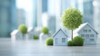 © gleb - Miniature model houses and trees on reflective surface with urban skyline blur ideal for eco housing concepts, real estate ads and sustainable living visuals