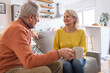 © BrightGridVisuals - Senior Couple Enjoying Tea Together on Couch