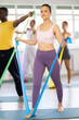 © JackF - Group of athletes train in a Pilates class using elastic bands
