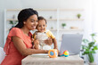 © Prostock-studio - Black Young Woman Study With Laptop At Home And Taking Care About Her Little Child, African American Mother Using Computer For Distance Learning, Watching Online Webinar Or Attending Virtual Lesson