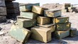 © IzzExpert - Pile of old military ration tins scattered in disarray outdoors with worn metal containers stacked on the ground