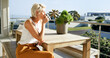 © Kobus Louw/peopleimages.com - Home, woman and relax with coffee on balcony for calm morning, sun basking and weekend break. Peaceful, mature person and drinking beverage outdoor at house for fresh air, start day or summer holiday