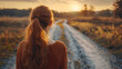 © syhin_stas - Young woman stands at a forked forest path, back to camera, contemplating two diverging routes-symbolizing choice, uncertainty, and deciding the next step in life's journey