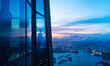 © xy - Successful businesswoman in suit standing in office looking through window at big city buildings, planning new project in the evening