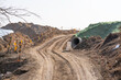 © anuu - construction site with dirt road and barren land under clear sky, showing early stage infrastructure development and wide open space for future projects.