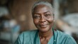 © FrameYesil - Warm portrait of African nurse in advanced medical environment, friendly smile and gentle eyes conveying trust, empathy, and dedication to patient care. cinematic color correction, natural uneven